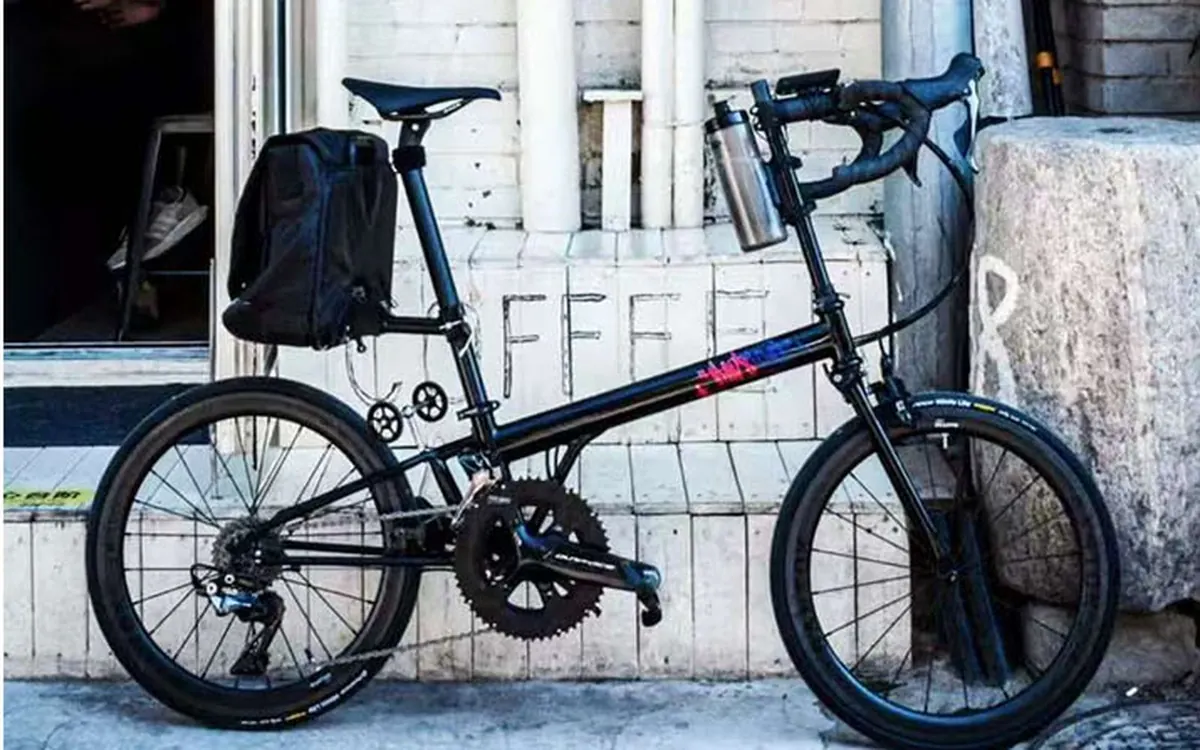 Small-wheel bike with a black rear pack on a Seatpost Hugger