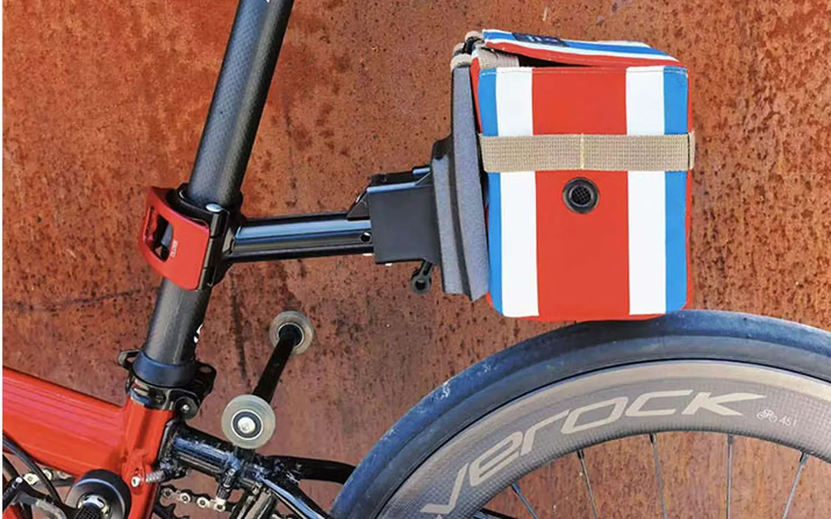 Striped rear bag on a red frame with a large quick-release lever