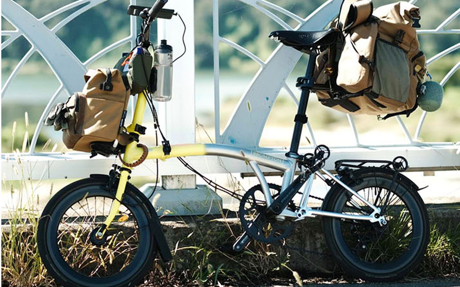 Yellow-and-silver Brompton with front and rear bags