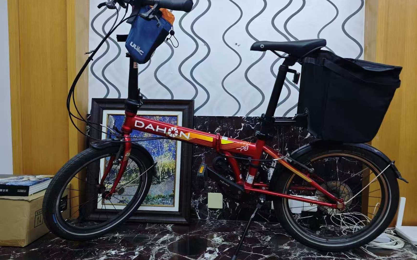 Red DAHON P8 with a black rear cargo bag on the seatpost